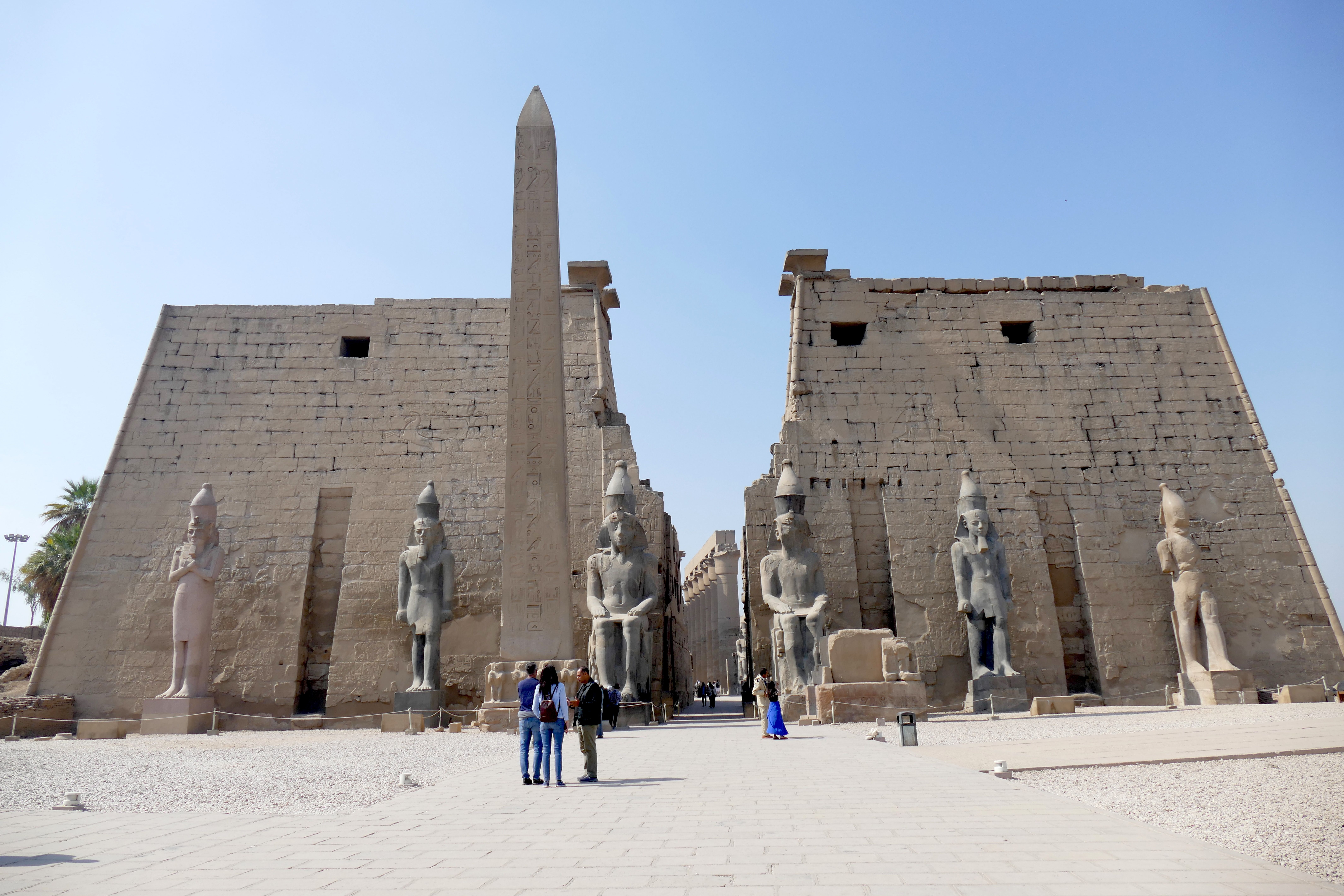Visitors explore Luxor Temple and its monumental statues, illustrating time for ancient sites in Upper Egypt.